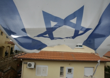 An Israeli flag hangs near a house in Bruchin; a young Jewish town located on the hills of Shomron. March 03, 2009. Photo by Uri Lenz/Flash90 *** Local Caption *** ??????
???
??