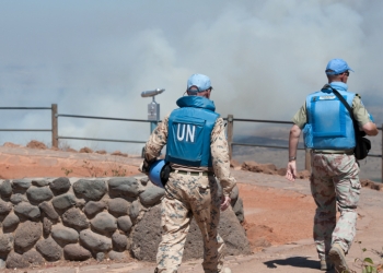 UN soldiers walk as Smoke rises near Quneitra Crossing as it seen from the Golan Heights in the Israeli side on August 27, 2014, The IDF instructed farmers and civilians on Wednesday to stay away from the border with Syria on the Golan Heights. The measure came after intense fighting between the Syrian army and rebels in the Quneitra  crossing region. Photo by Flash90
  *** Local Caption *** ????
?????
?????
???
??
????
????
??????
????
???? ???????
?????
?????
?????