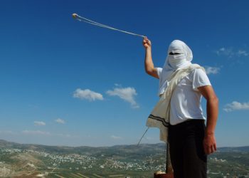 A masked Jewish settler swings a slingshot as he stands near the West Bank Jewish settlement of  Mitzpe Yitzhar, on May 19, 2013. Photo by Mendy Hechtman/Flash90 *** Local Caption *** ???? ????
?????
????
??????
???? ????