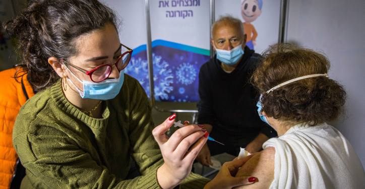 People receives a Covid-19 vaccine, at Clalit Covid-19 vaccination center in Jerusalem, on December 29, 2020.  Photo by Olivier Fitoussi/Flash90 *** Local Caption ***  ??? ????
???????
????
??????
?????
?????
??????
???????
