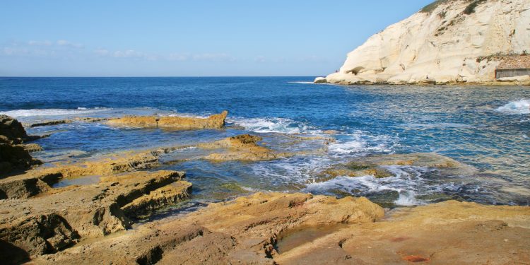 Rocks and white chalk cliff at Rosh HaNikra reserve on Mediterranean sea in Israel.