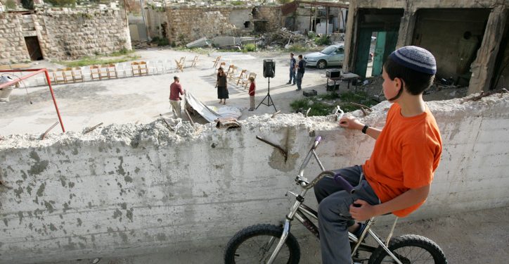 Young Jewish kid sits on his bicycle and looks on in the street of the Jewish neighborhood in the Old City of the West Bank city of Hebron on Monday, Apr 20, 2009. Photo by Kobi Gideon / FLASH90. *** Local Caption *** ?????
???? ?????
???
?????
???????
????
????
???????