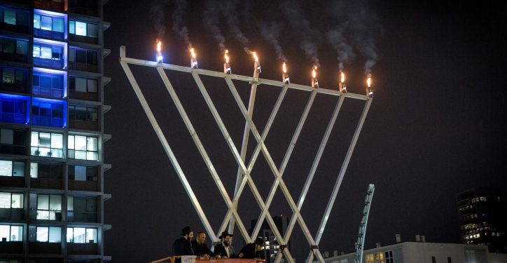 Jewish families look on as Chabad light a large 'chanukia'  for the Jewish holiday of Hanukkah, on Rabin square in Tel Aviv on December 18, 2017. Hanukkah, also known as the Festival of Lights, is an eight-day Jewish holiday commemorating the rededication of the Holy Temple. The festival is observed by the kindling of the lights of a 'hanuckia'- a nine-branched candelabrum, with one additional light being lit on each night of the holiday. Photo by Miriam Alster/Flash90 *** Local Caption *** ?????
???????
?????
????
???? ????
?? ????
??''?