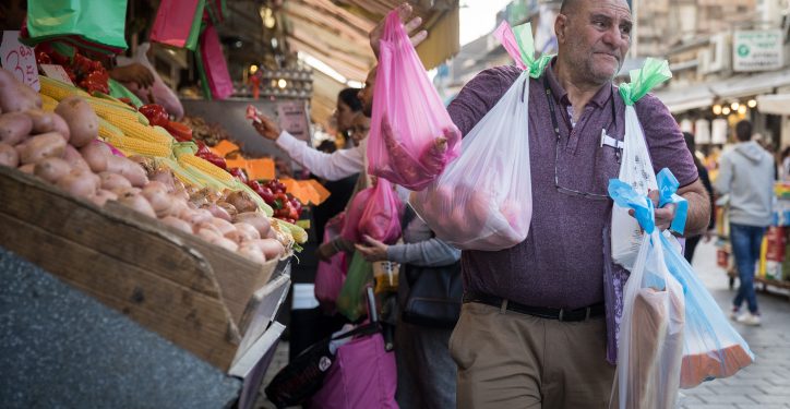 A man carries plastic bags with his groceries at the Mahane Yehuda Market in Jerusalem, on November 26, 2019. Photo by Hadas Parush/Flash90 *** Local Caption *** ?????
????
?????
??? ???? ?????