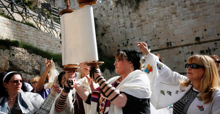 Religious Jewish women which are part of the Women of the Wall organization wear tfillin (prayer shawls) and tallit as they read from the Torah and pray at Robinson's Arch,  near the Western Wall in Jerusalem. The WOW organizes women's prayer groups at the Western Wall at the start of every new Jewish month (Rosh Hodesh). Jewish ultra orthodox communities oppose women's singing in the presence of men, reading from the Torah, and wearing the ritual garments and objects traditionally associated with men. March 12, 2013. Photo by Miriam Alster/FLASH90  *** Local Caption *** ???? ?????
????
????
????
