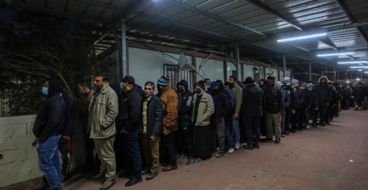 Palestinian workers wait at the Erez crossing in Beit Hanun, in the northern Gaza Strip, as they wait to enter Israel for work, on March 13, 2022. Photo by Attia Muhammed/Flash90  *** Local Caption *** ????
???
?????
??????
???
?????
?????
?????????
??
??????
?????